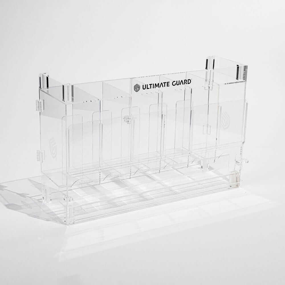 Accessoires Stackable and expandable dispenser for trading card booster packs, deck boxes and more. With high-quality 100% acrylic panels, 6 compartments and front slots for displaying booster packs and a top shelf for displaying accessories.- High qualit