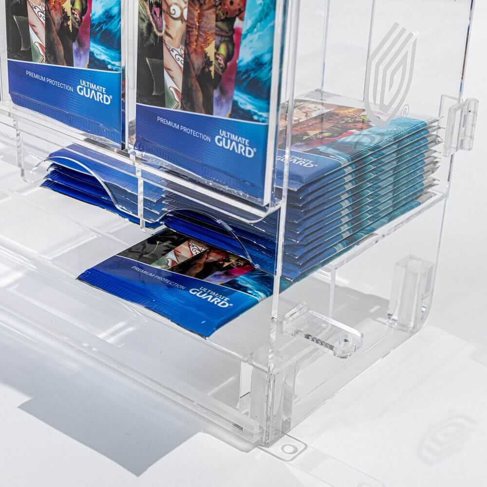 Accessoires Stackable and expandable dispenser for trading card booster packs, deck boxes and more. With high-quality 100% acrylic panels, 6 compartments and front slots for displaying booster packs and a top shelf for displaying accessories.- High qualit